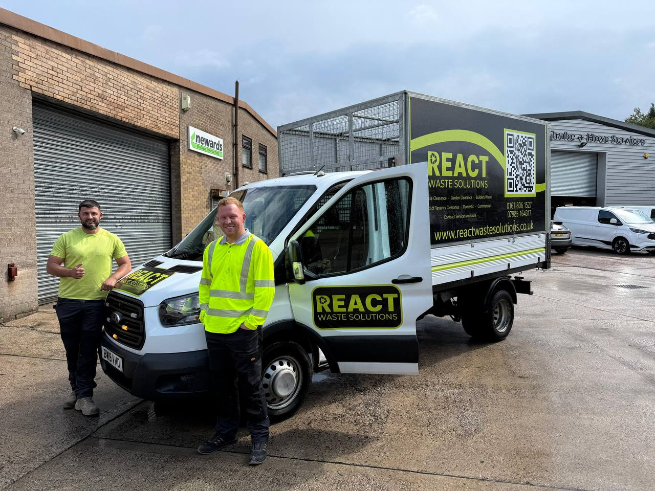 React Waste Solutions team members standing beside a branded waste collection truck outside an industrial unit.